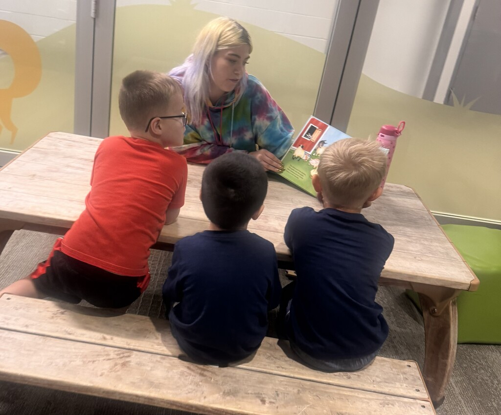 A CHS student reading to Pre-K students.