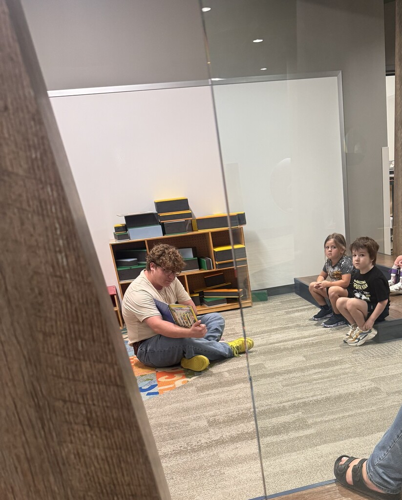 A CHS student reading to Pre-K students.