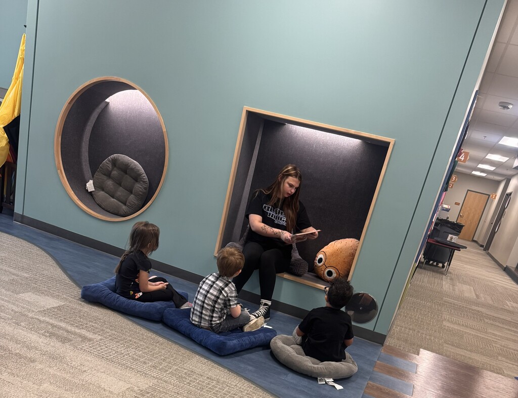 A CHS student reading to Pre-K students.