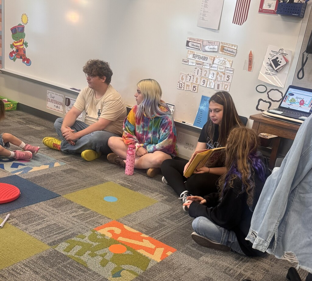 A CHS student reading to Pre-K students.