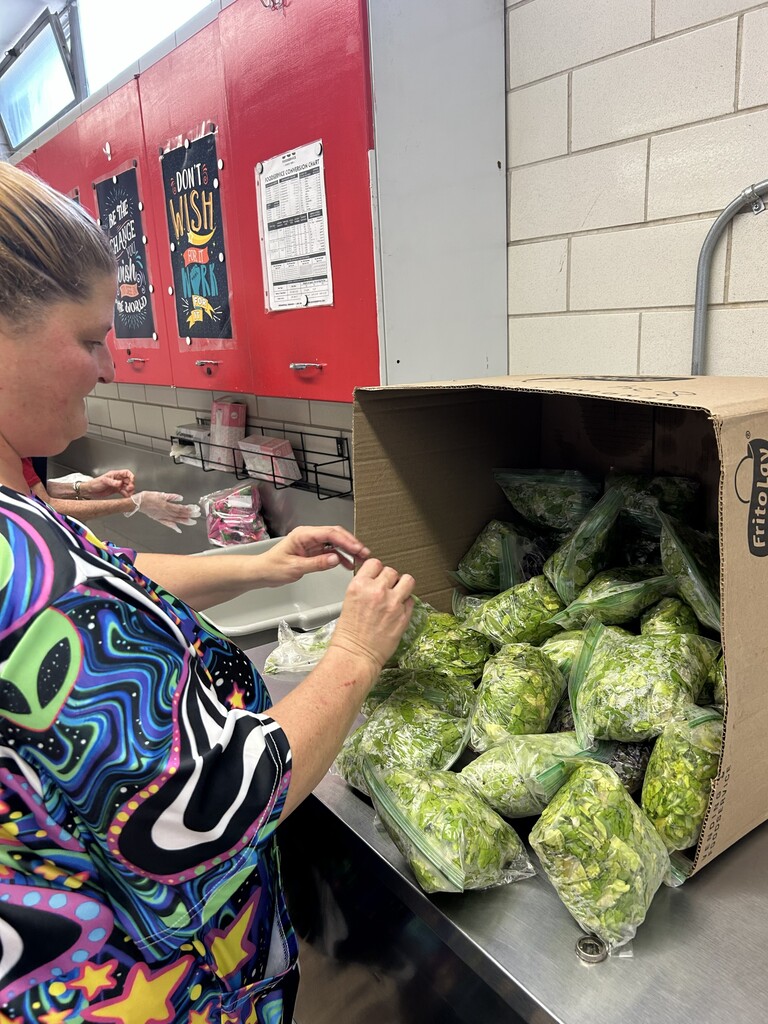 CMS Cafeteria Manager Elizabeth Spainhour gets the lettuce from Table Top Farms ready for lunch Tuesday at CMS.