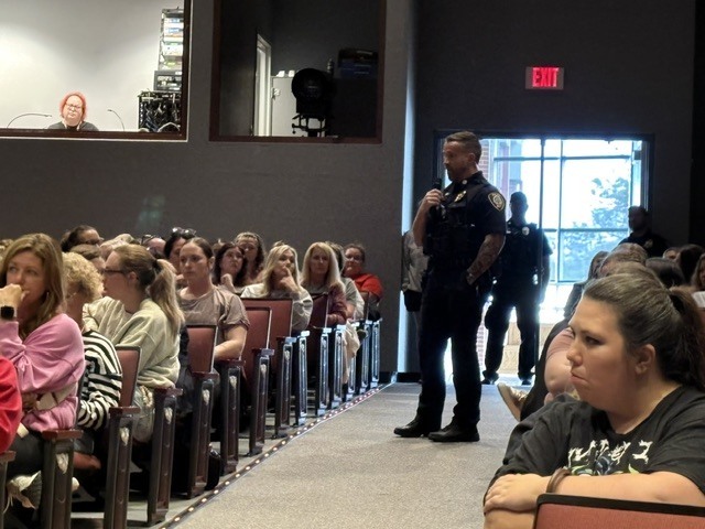 SRO Andy Clark in the Performing Arts Center with Chillicothe R-II Staff following the intrudor drill at CES for debriefing
