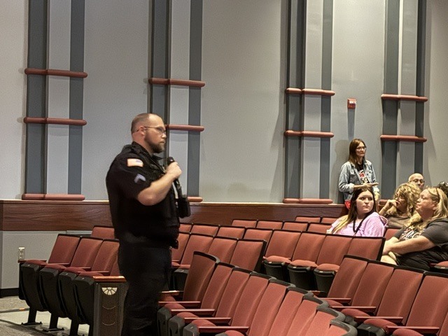 SRO Hogan in the Performing Arts Center with Chillicothe R-II Staff following the intrudor drill at CES for debriefing