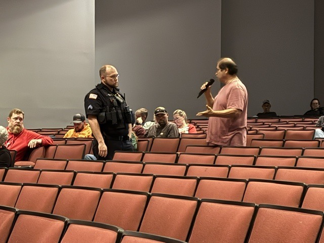 SRO Hogan in the Performing Arts Center with Chillicothe R-II Staff following the intrudor drill at CES for debriefing