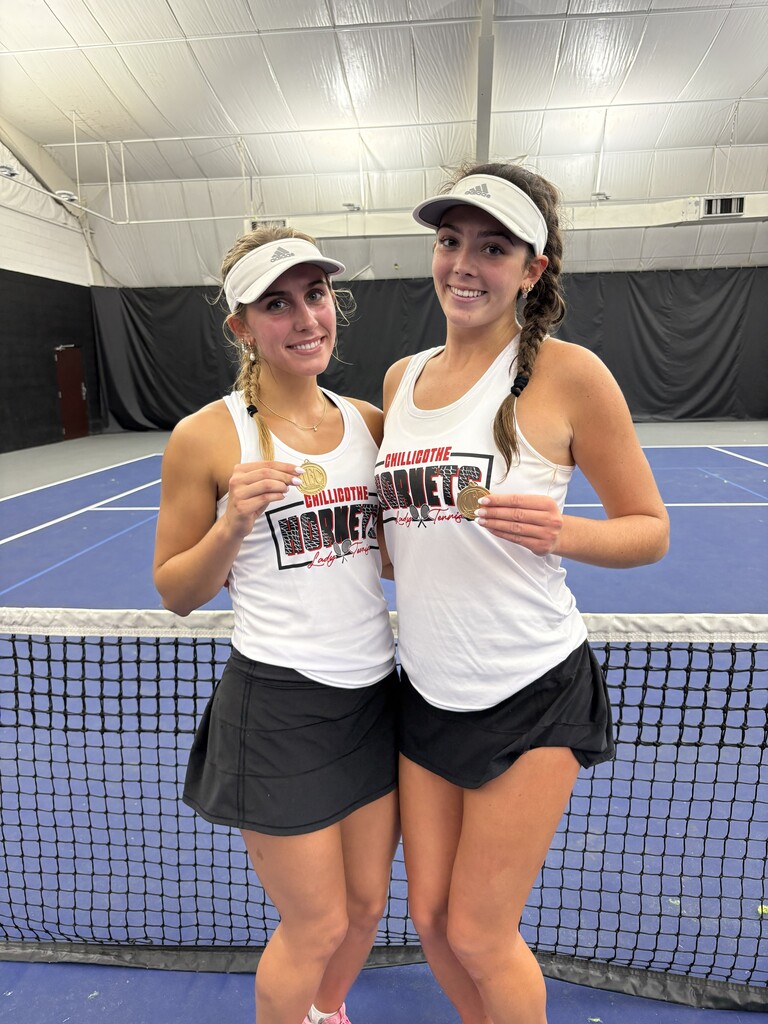 Lexy Smith and Lydia Bonderer - back-to-back MEC Conference Doubles Champions. they are shown with their medals on the tennis courts.