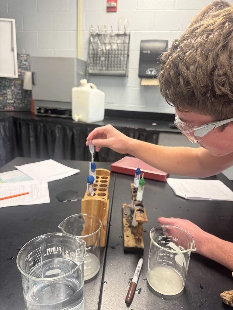 A chemistry student works on building mini-rockets.