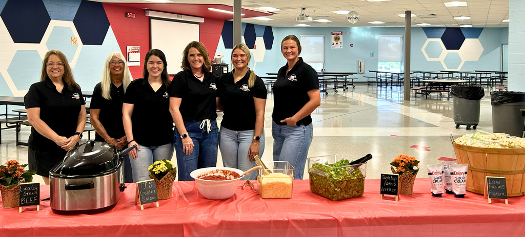The Cattleman's Association members stand by a table of food. They provided the beef for the walking tacos durig the Fall Fun night at CES last night.