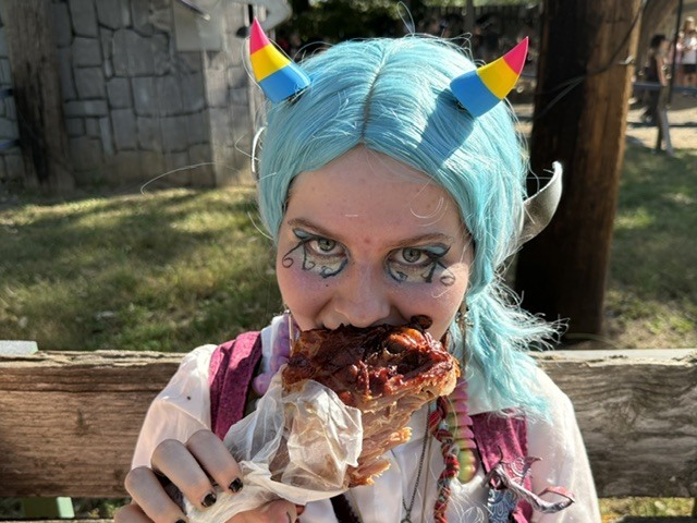 Sophia Coon enjoys a turkey leg at the Renaissance Festival on October 10.