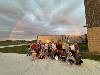 A group of CES students in front of a rainbow this morning.