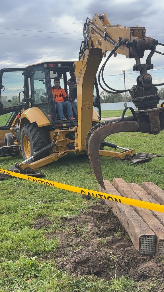 Trent Menconi operates a track hoe.