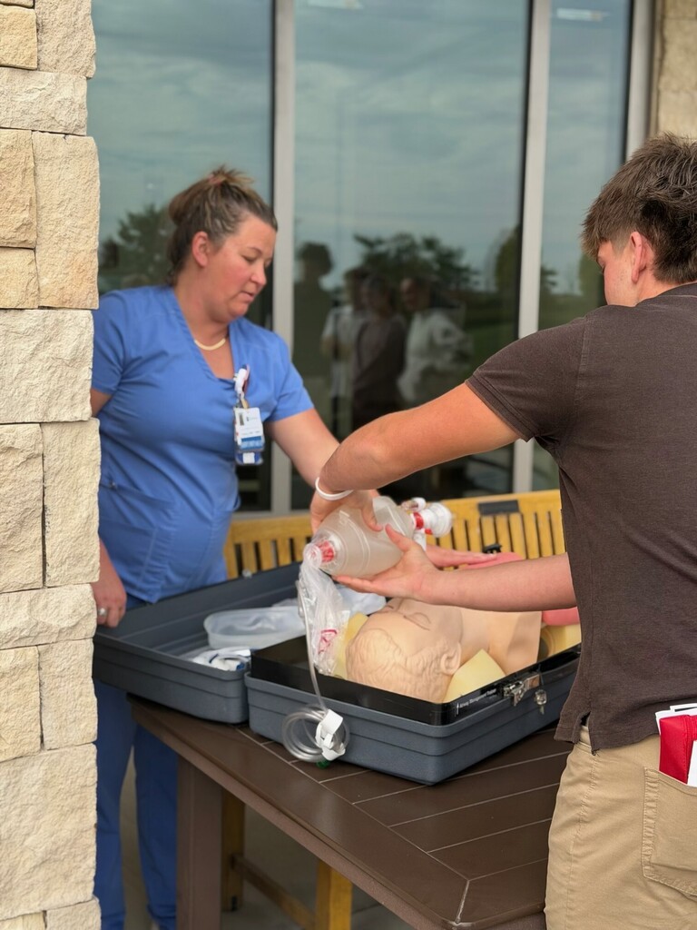 A student works on a dummy at the Hedrick Medical Center.
