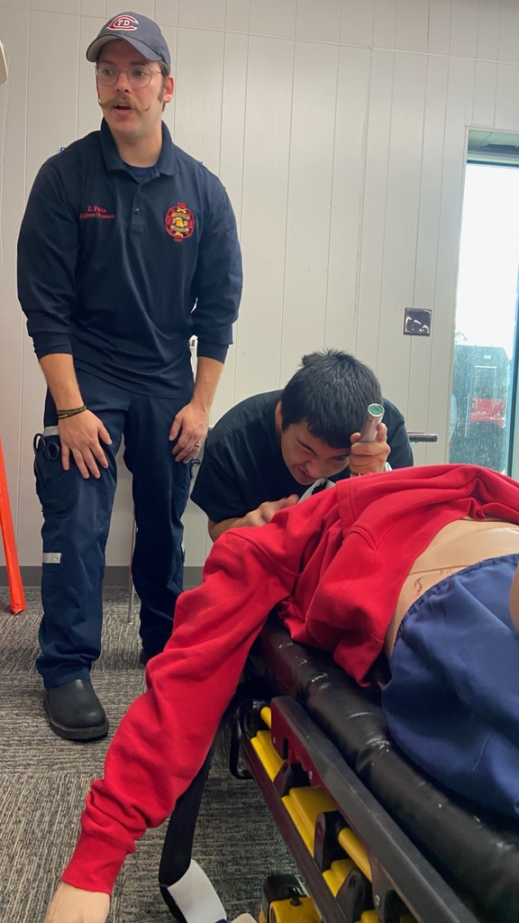 A Health Service Tech student on a stretcher 