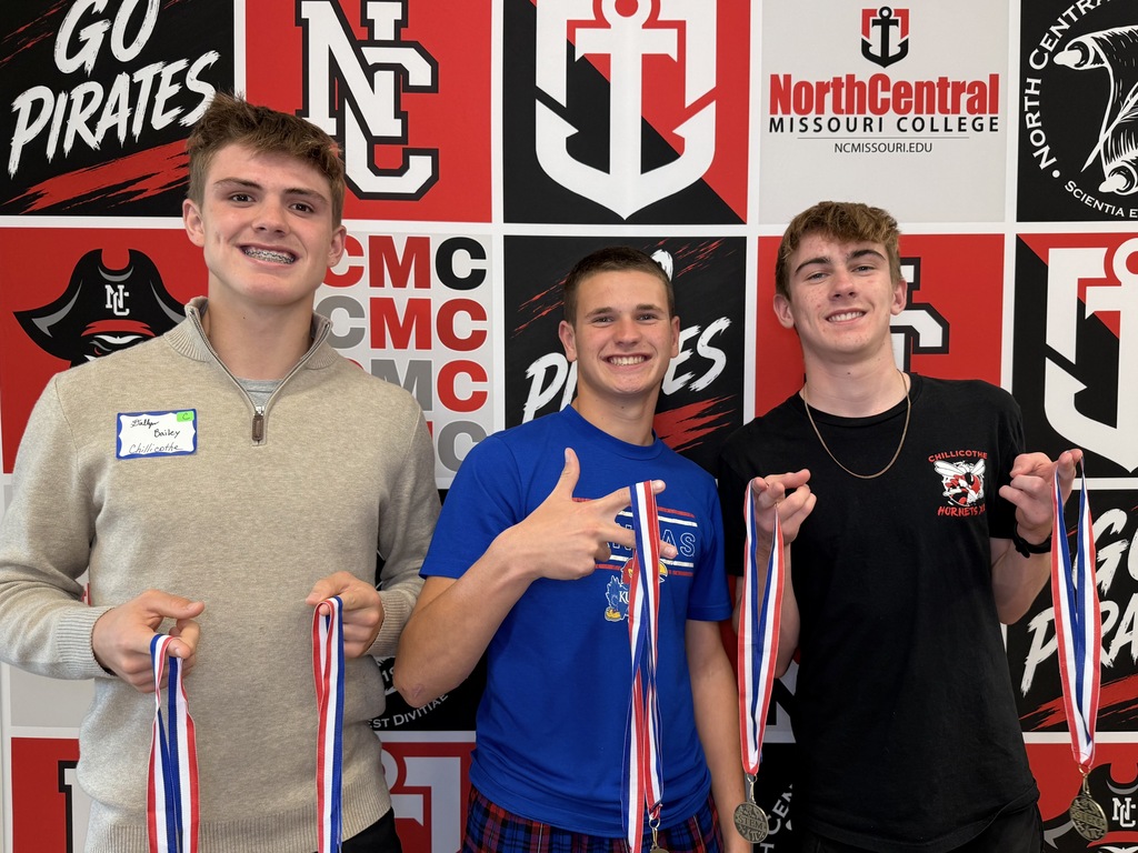 Dallyn Baileey, Jace Collins and Brody Norris holding medals after the Life Science team competition.