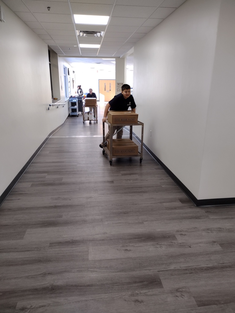 7th Graders bringing in the books.