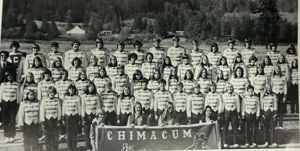 Old black and white photo of the Chimacum Band holding the Chimacum Band banner and posing for photo.