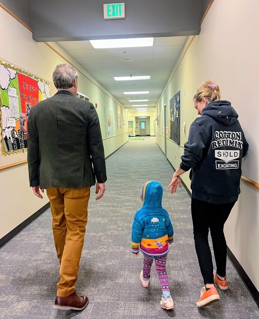 CCP hallway with 3  people on a tour to see the school.