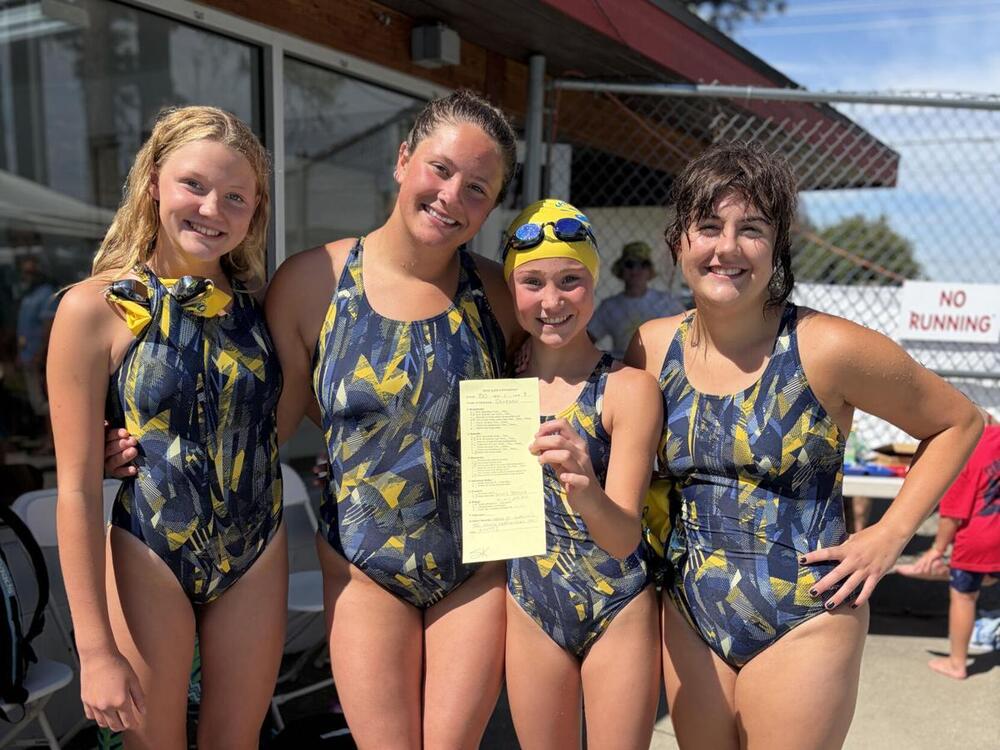 From left, Vera Kesler, Emily Thompson, Harper Hlavac and Addison Christensen pose with their team's disqualification sheet after they purposefully swam the strokes in the wrong order to have some fun during the Columbia Falls swim meet.