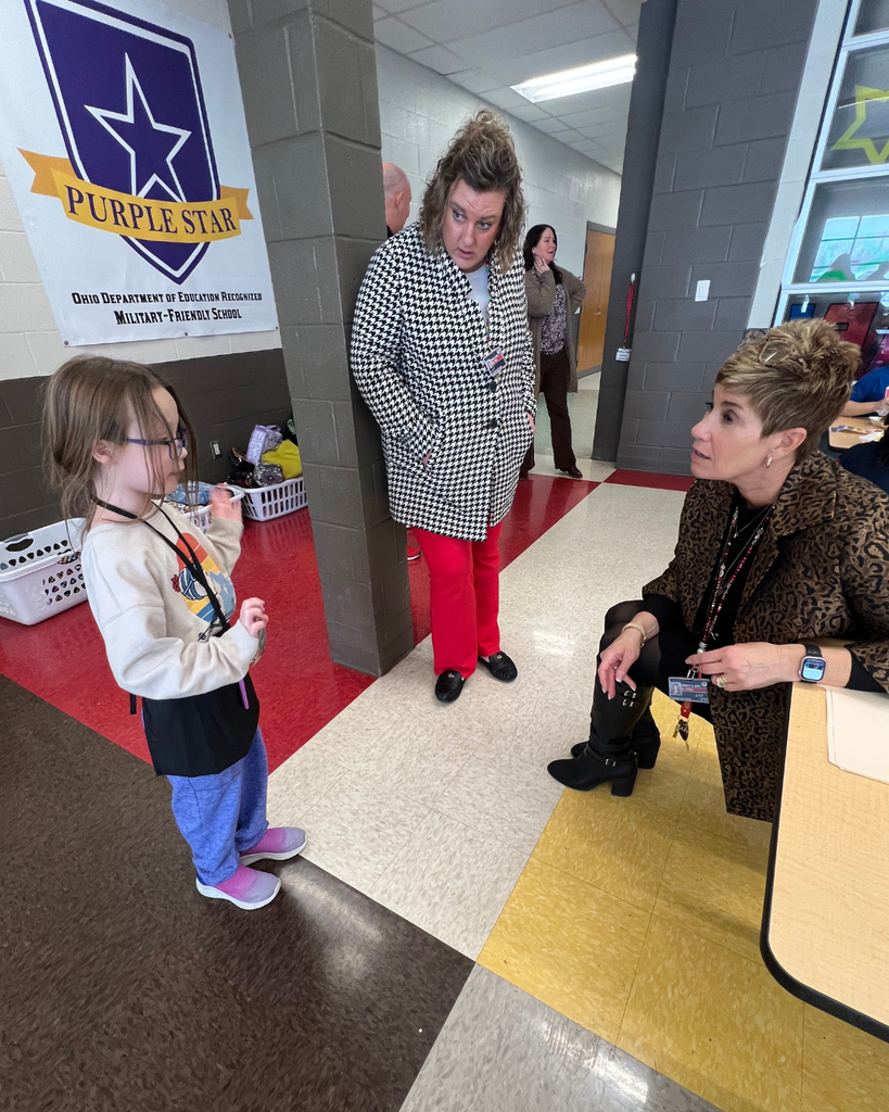 Dr. Halley and Mrs. Sims listening to a lunch helper explaining her role