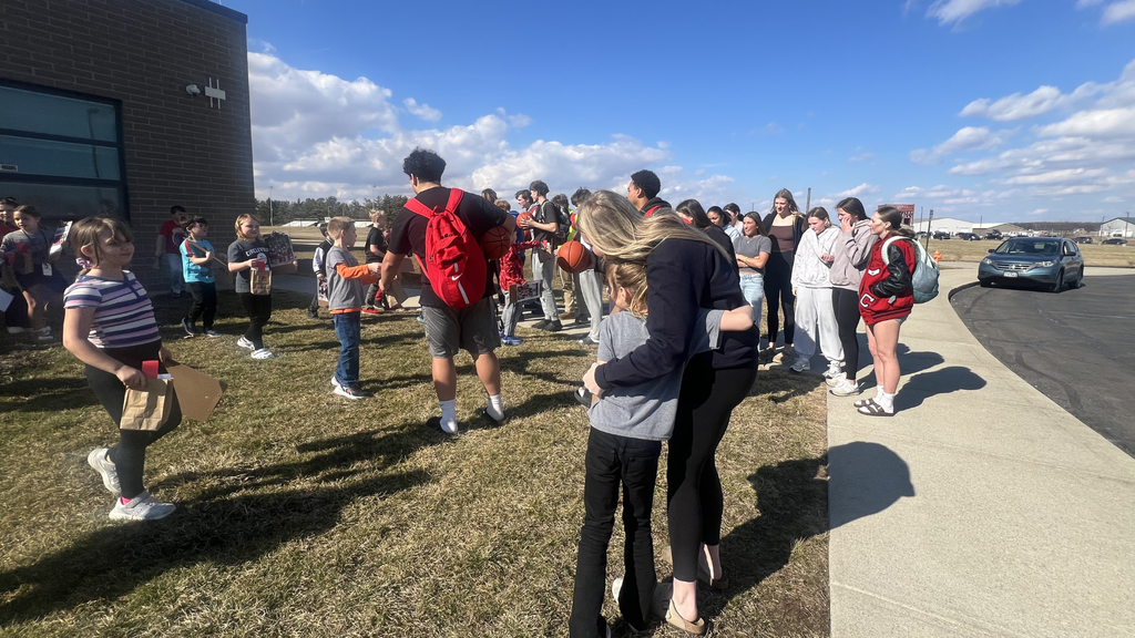 students celebrate members of the boys and girls basketball teams