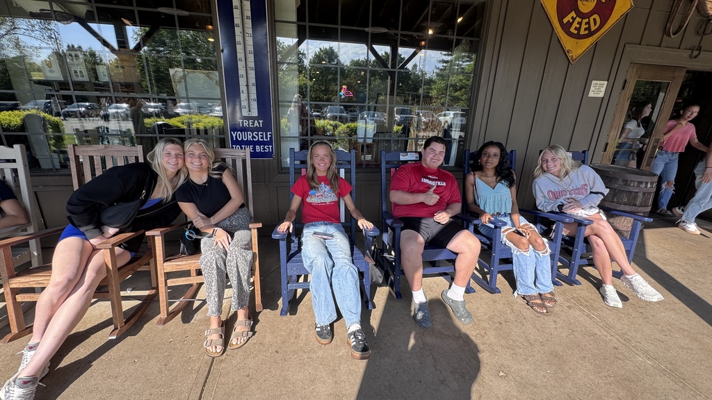 students sitting in rocking chairs