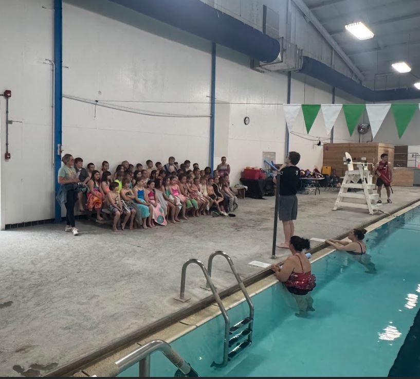 children listening to life guard before swimmng