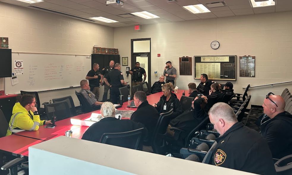 police and staff reviewing plans for the safety drill