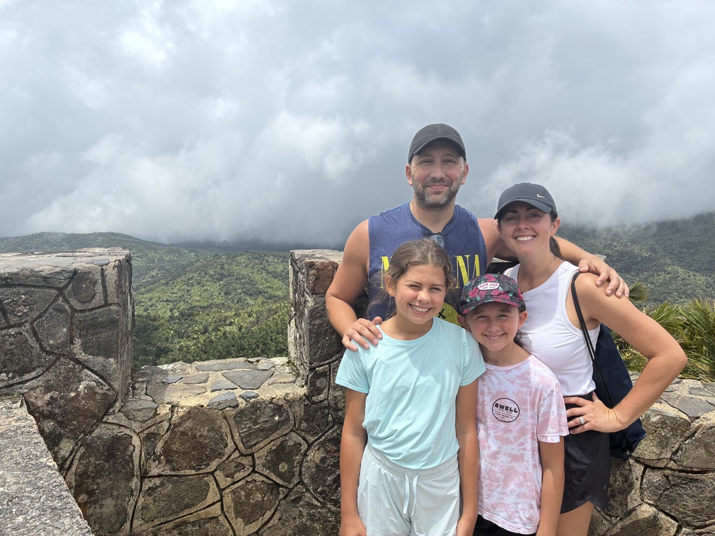 addy and emmy conn posing with their parents in puerto rico