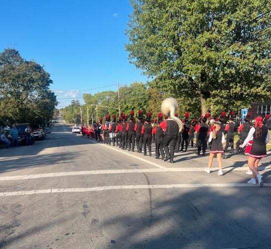 band and cheerleaders marching in the homecoming parade