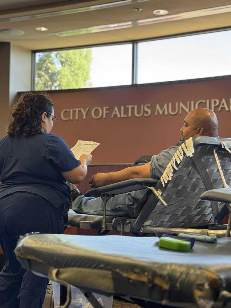 A medical worker assists a man donating blood inside the City of Altus Municipal Complex during the Wicked Good Donors Blood Drive.