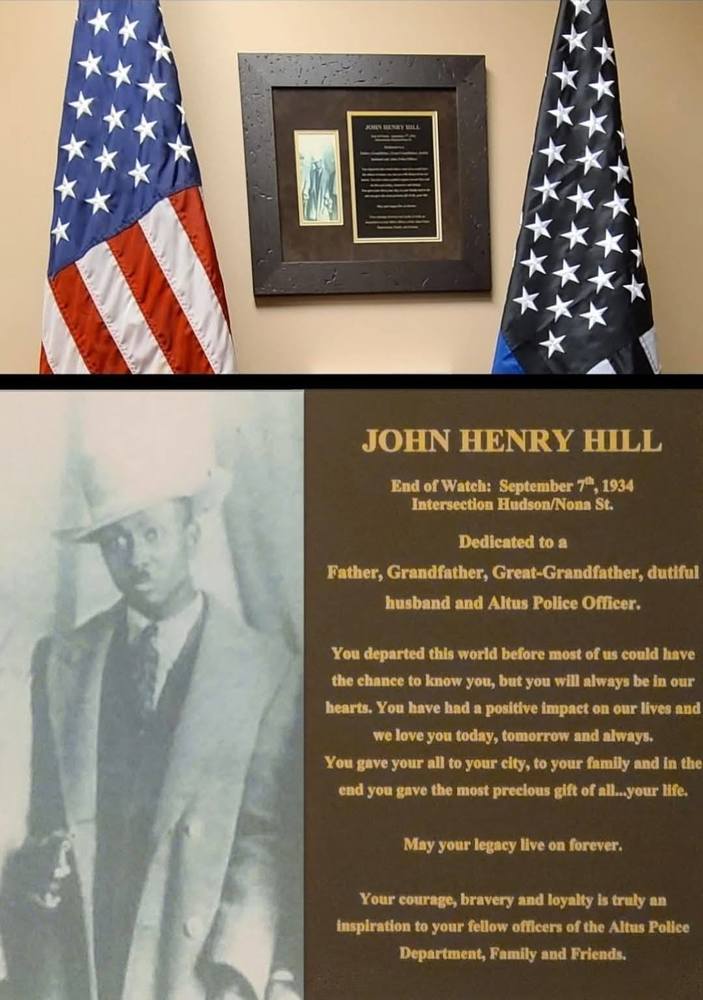 A framed memorial plaque for Altus Police Officer John Henry Hill is displayed between an American flag and a Thin Blue Line flag. Below, an enlarged photo of Officer Hill in a suit and hat is shown next to an inscription honoring his service and sacrifice. The plaque notes his End of Watch on September 7, 1934, and describes him as a father, grandfather, husband, and Altus Police Officer whose courage and loyalty continue to inspire.
