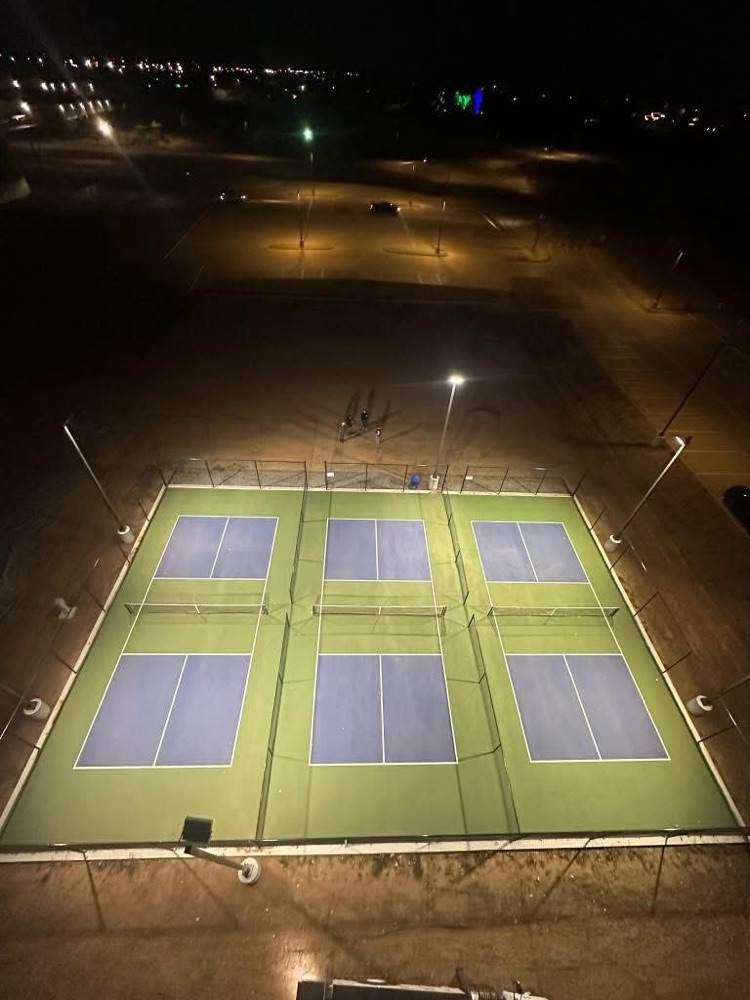 nighttime Pickleball court lit up with their new lights