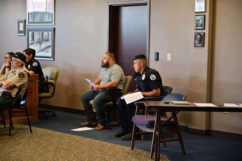 Two Police Officers sit and take notes during class