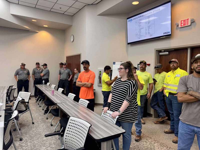 City of Altus employees standing in rows inside a training room, listening to the session