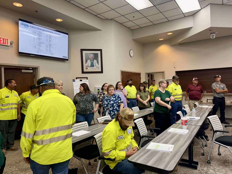City of Altus employees in high-visibility safety jackets attending customer service training in a classroom