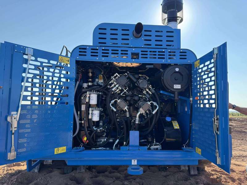 Rear view of the Aljon 500 compactor with its engine compartment doors open, showing internal machinery and engine components.