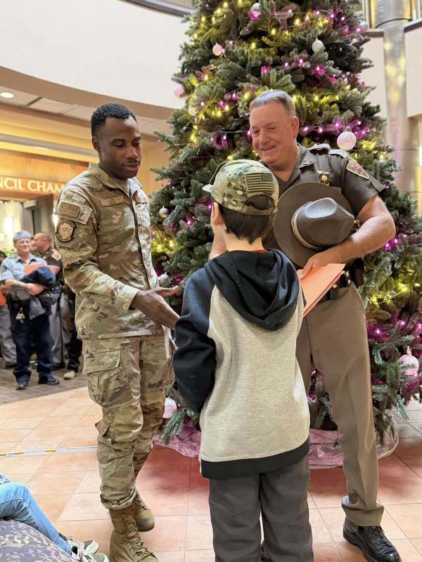 Police officers help families select gifts during the Cops and Kids Christmas shopping event.