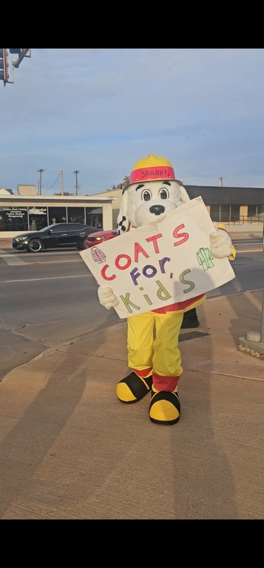 Firedog Coats for Kids sign outdoors.