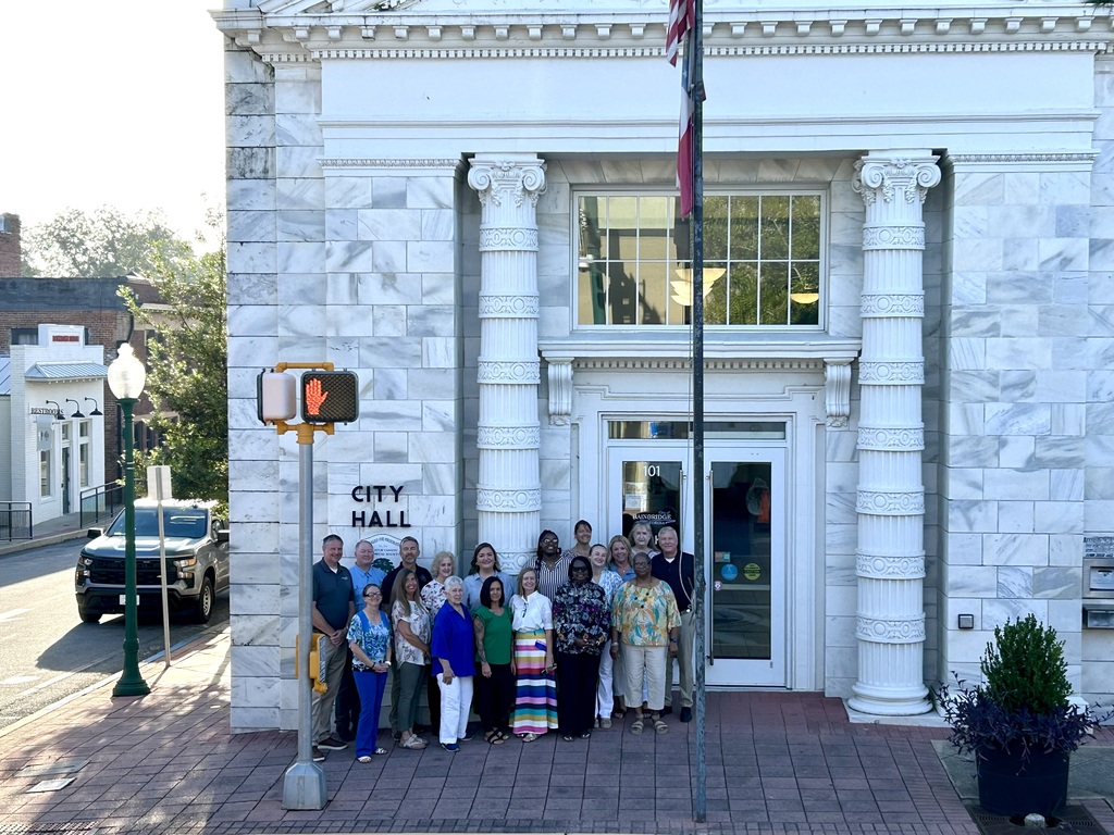 city staff pictured standing in front of city hall