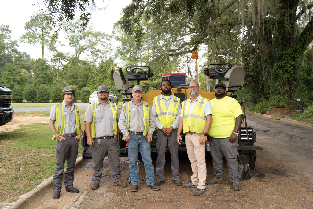 6 street department employees pictured in front of equipment on Evans St in Bainbridge 