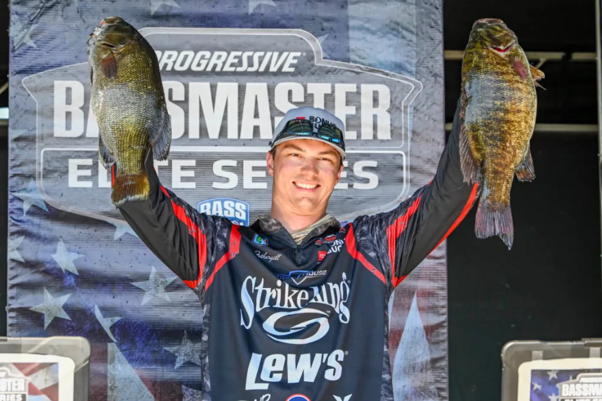 Easton Fothergill holding two fish above his head photo credit: Bassmaster