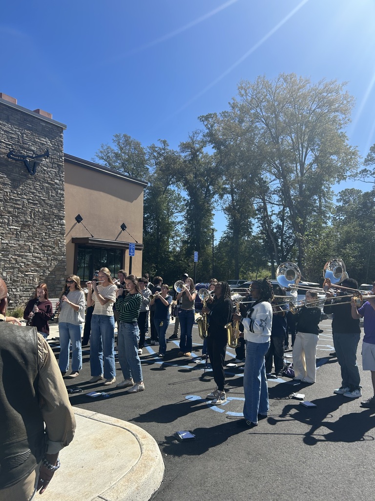 members of the bainbridge high school band performing in front of longhorn steakhouse