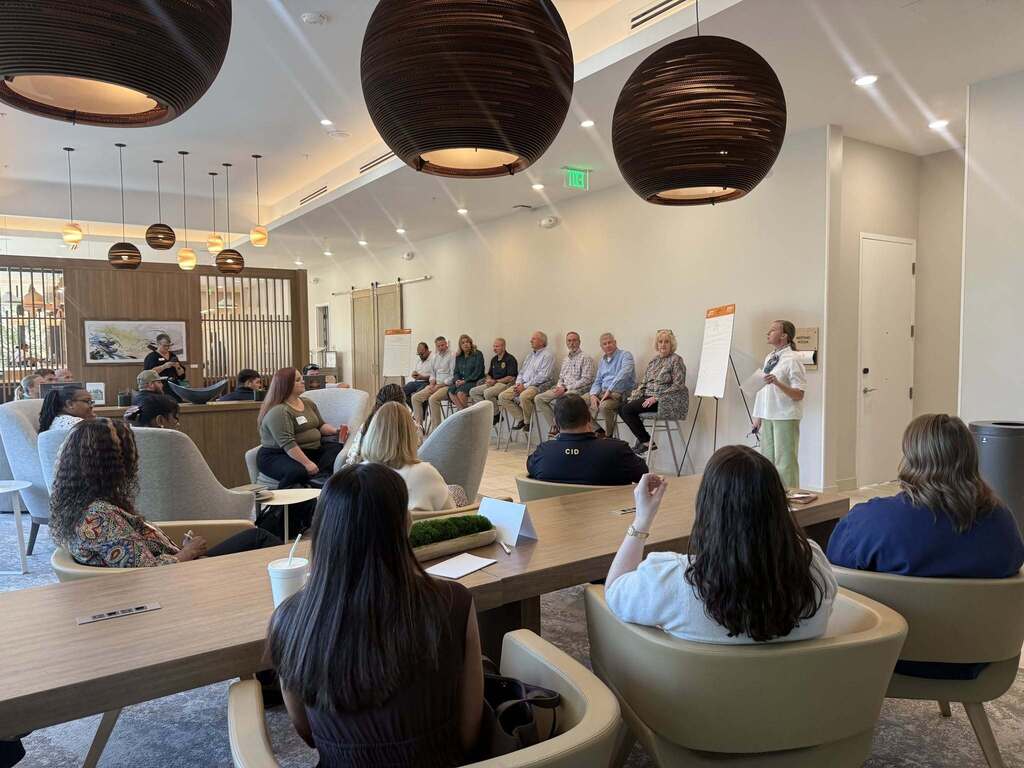 Wide view of a panel discussion during the First National Bank Leadership Decatur County session. City and county government representatives sit at the front of the room while participants listen and engage in a discussion about local government.