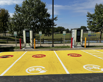 Electric vehicle charging stations and parking spots
