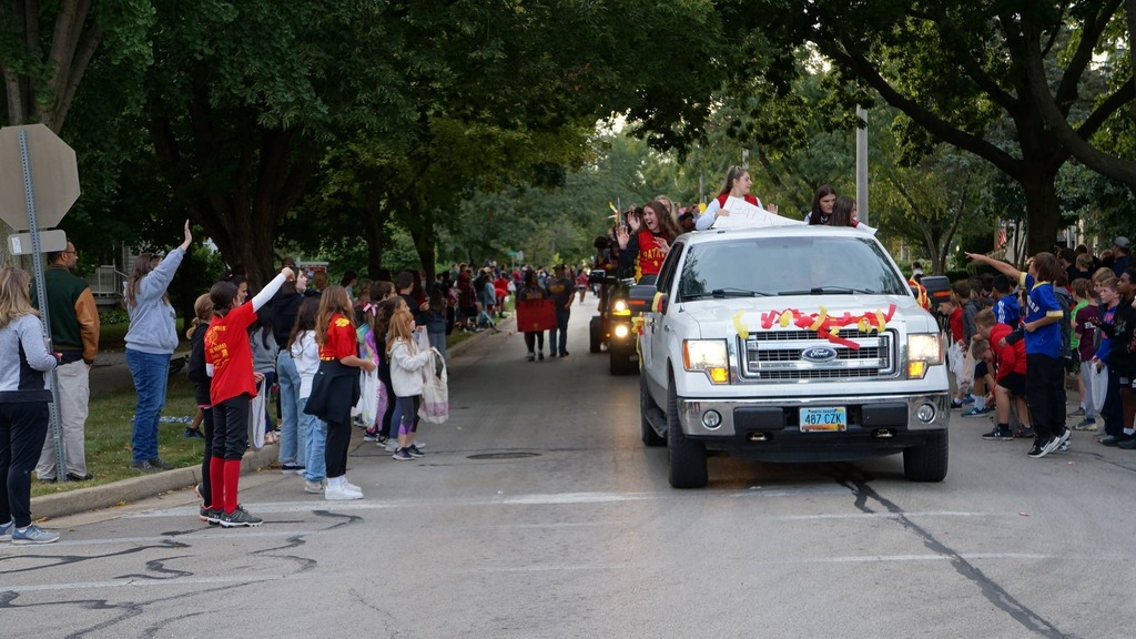 pickup truck on parade route with kids watching