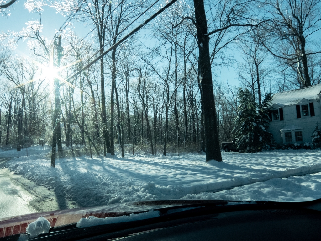 snowy winter street and car dashboard