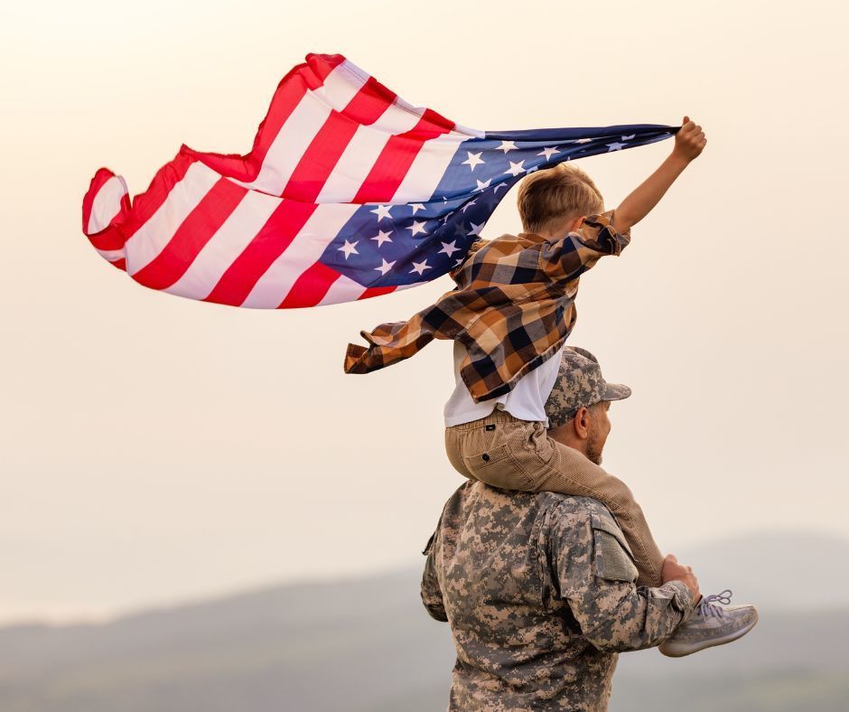 A boy holding an American flag.