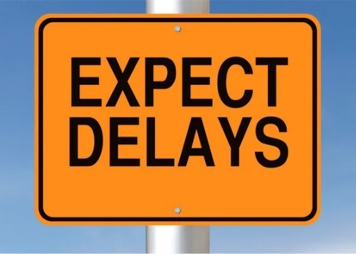 A Yellow Sign that states "Expect Delays"