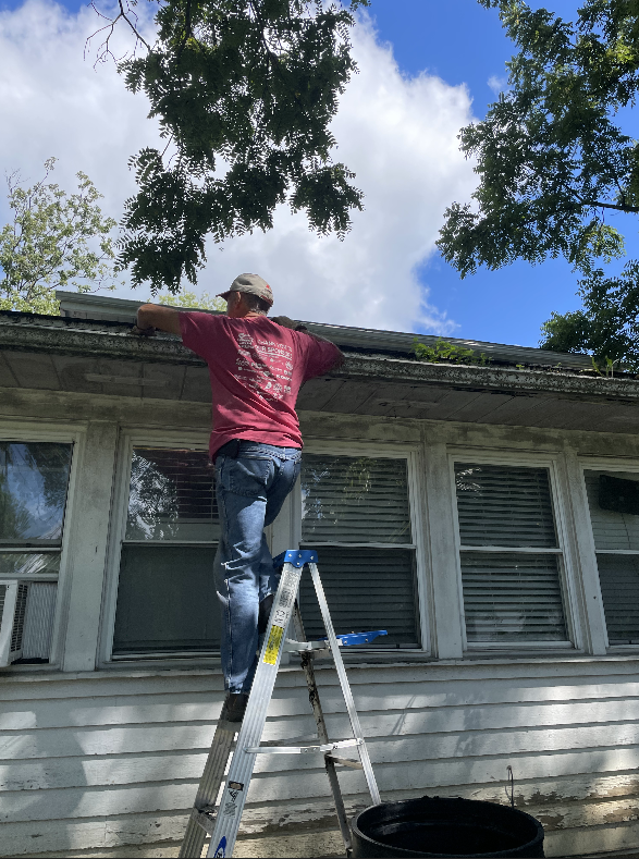 Volunteer Cleaning out Gutters