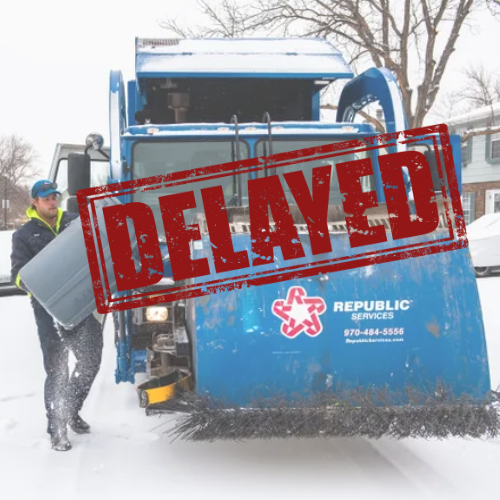 Garbage truck in snow with a worker loading bins, flanked by snow-covered houses and trees. A large red "DELAYED" stamp is overlaid on the image.