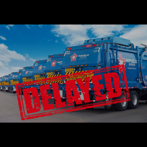 A line of blue garbage trucks labeled "Republic Services" under a clear sky, with a bold red "Delayed" stamp across the image, indicating a delay.